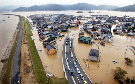 Yura River and collapsed embankments flood roads and houses due to typhoon in Maizuru, Japan