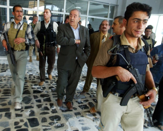 Iraqi Prime Minister Ayad Allawi, center, is surrounded by bodyguards as he makes his way to a meeting in Mosul, northern Iraq, on Thursday.