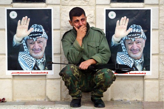 A member of Yasser Arafat's elite personal security unit, Force 17, weeps outside the Palestinian leader's former headquarters in Gaza City on Thursday morning after hearing of Arafat's death.
