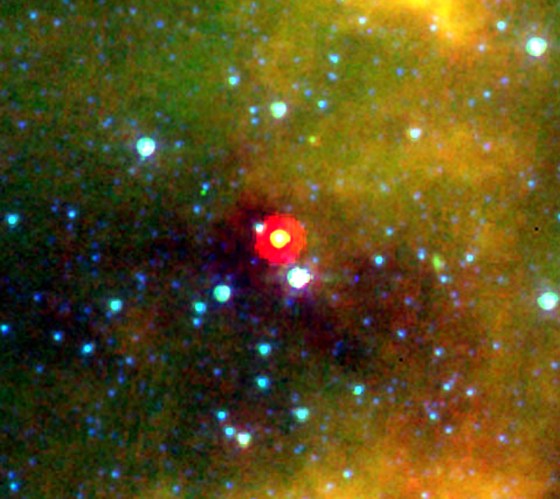The warm spot shown at the center of this image is known as L1014, the 1,014th object in a list of dark, dusty "clouds" compiled by astronomer Beverly Lynds. These have proved to be homes to a rich variety of molecules and are the birthplaces of stars and planets. 