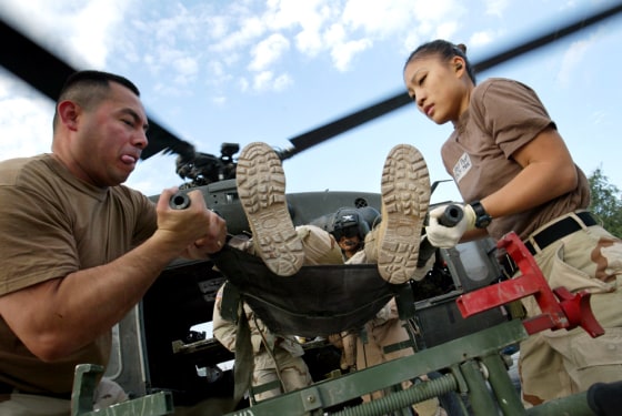 U.S. Army personnel receive an American soldier with shrapnel wounds to the head at the 31st Combat Support Hospital in Baghdad, Iraq, on Monday.