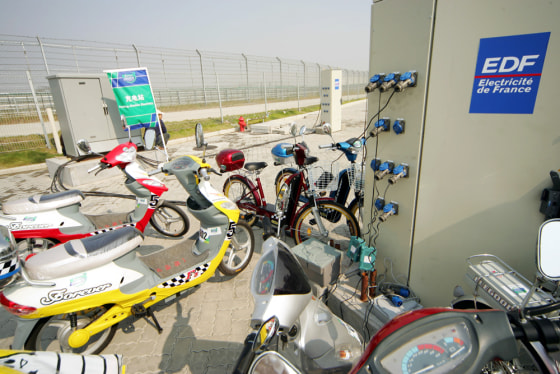 Chinese-made electric scooters and bikes get recharged at the 2004 Challenge Bibendum, a green vehicle rally for carmakers. The event was held in Shanghai last October. The recharging station was provided by EDF, France's electric utility company.