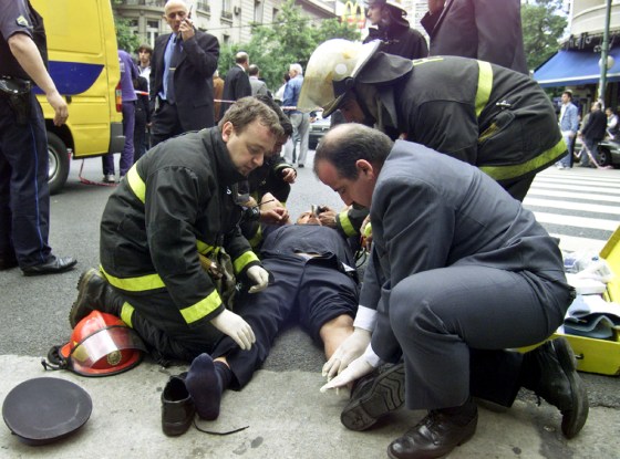 Security guard gets aid after explosion struck a Citibank branch in Buenos Aires