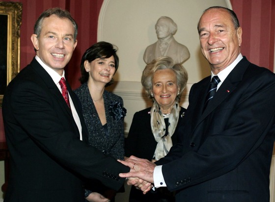 Prime Minister Tony Blair, left, shakes hands with President Jacques Chirac, right, as their wives, Cherie Blair, 2nd left, and Bernadette Chirac look on prior to their meeting Thursday.