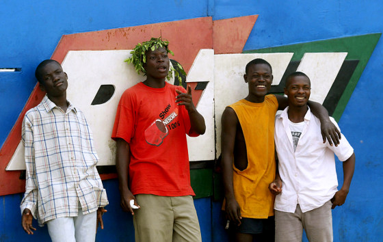 Anti-French protesters stand Thursday at the main gate to RTI, Ivorian Radio Television in Abidjan, Ivory Coast. 