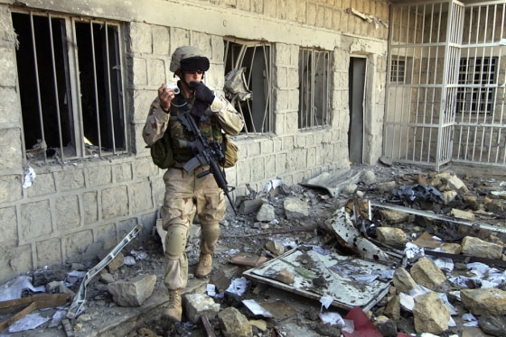 A U.S. Army soldier on Sunday photographs the destruction in an Iraqi police station damaged in a recent insurgent attack in Mosul.