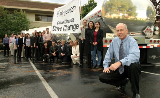 Hyperion CEO Godfrey Sullivan, right, poses with 25 employees and a gasoline truck to make the point that a double-tanker full of gasoline will be saved in one year by the participation of just 25 employees in its clean car program.