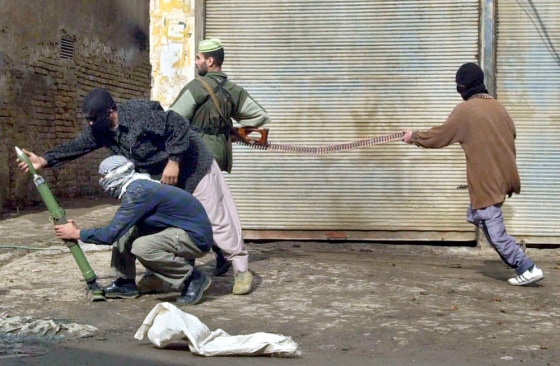 Insurgents load weapons during an attack on U.S. forces in Fallujah, Iraq, on Nov. 8 during a major assault on the insurgent stronghold. 