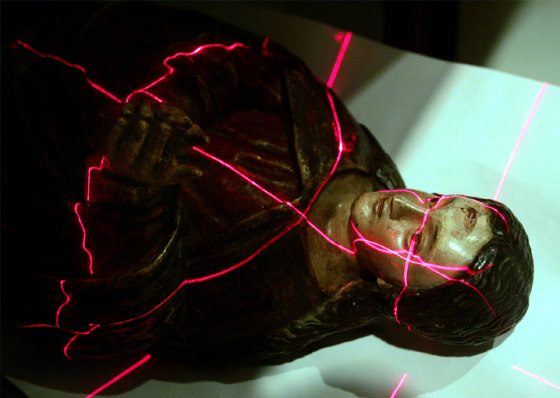 An 18th century colonial wood carving of the Virgin Mary is put into a tomography CAT scan