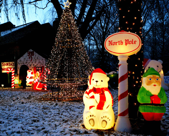 Holiday decorations and high-tech, computer-coordinated lights fill Greg Parcell's front yard in Geneva, Ill. 