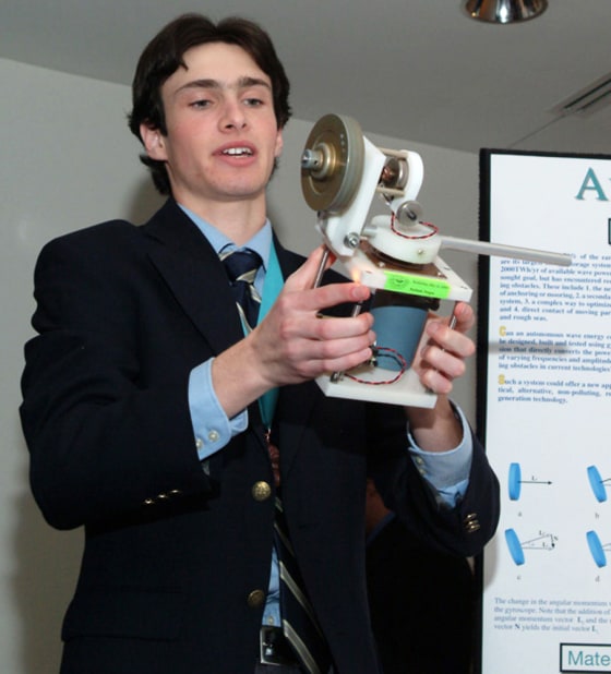 Aaron Goldin, the grand prize winner in the 2004-05 Siemens Westinghouse Competition, holds a model of his invention, a gyroscope that converts ocean energy into electricity.