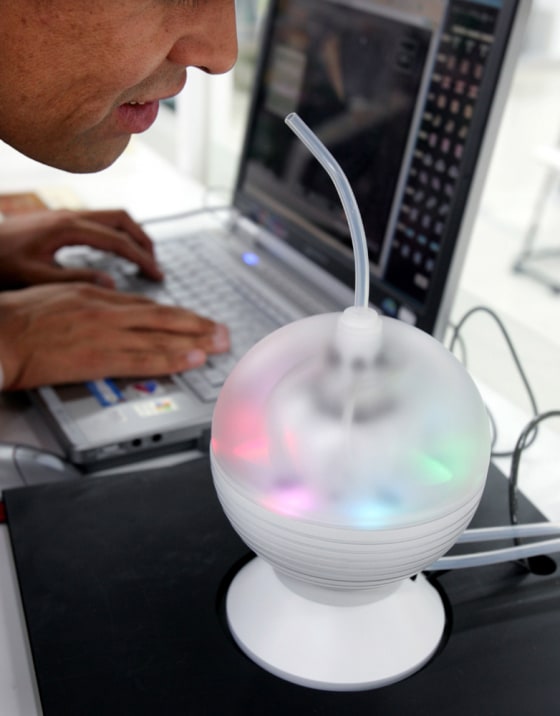 A Japanese man sniffs specially blended scent based on information provided through Internet in Tokyo