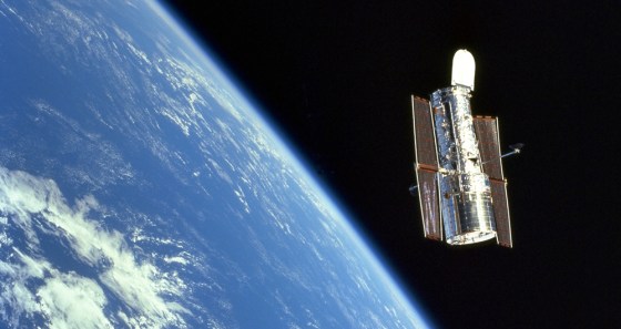 The Hubble Space Telescope floats above Earth after its release from the shuttle Discovery, at the end of a successful servicing mission in 1999.
