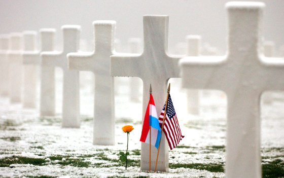 Luxembourg and U.S. flags grace the grave of an American during a memorial of the Battle of the Bulge on Thursday in Hamm, Luxembourg.