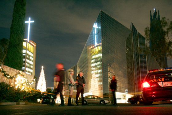 Law enforcement personnel block the entrance to the Crystal Cathedral complex after Thursday's shooting.