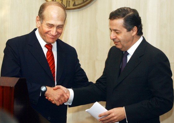 Israeli trade minister Ehud Olmert, left, shakes hands with his Egyptian counterpart Rashid Mohamed Rashid on Tuesday in Cairo.