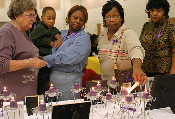 An emotional Saundra Adams holds her 5-year-old grandson, Chancellor, during a memorial service for victims of violent crimes&nbsp;at a local church in Charlotte, N.C. Her daughter Cherika Adams was killed five years ago but&nbsp;delivered Chancellor before dying.