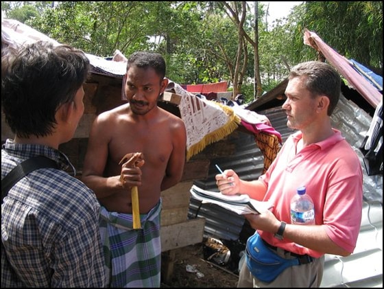 Australian doctor Richard Brennan and his interpreter are seen talking to a tsunami survivor in Calang, Indonesia. 