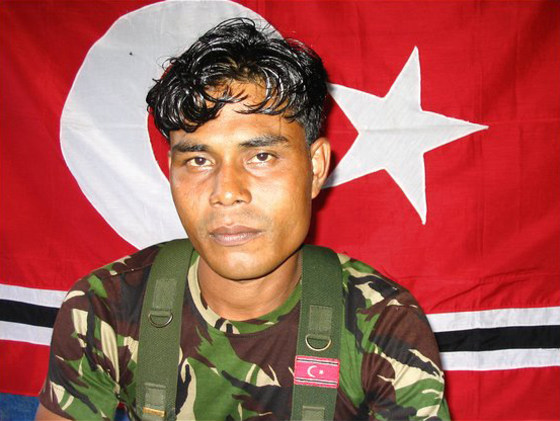 "What we had we gave to the refugees," said Muharram Idris, a rebel commander in the Free Aceh Movement in Indonesia. Muharram, sitting in front of the rebel flag, said all of his men had lost family in the tsunami.