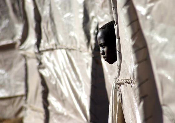 A displaced refugee boy looks out from his plastic tent in the Zam Zam refugee camp on the outskirts of El Fasher town, in the northern Darfur region of Sudan, on Nov. 22.