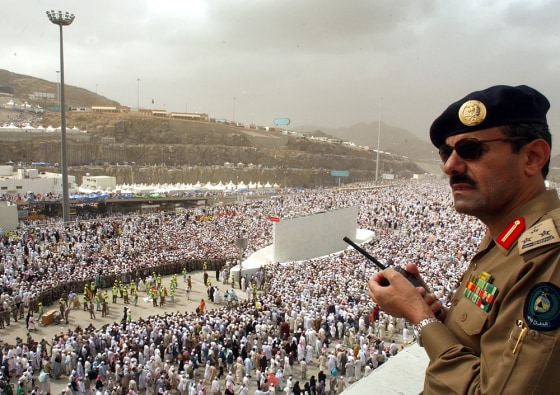 A Saudi police officer stands watching millions of pilgrims crowd to throw stones at pillars representing the devil in Mina, outside of Mecca, Saudi Arabia, Saturday.