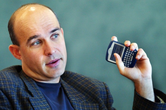 Research In Motion chairman Jim Balsillie holds a BlackBerry device. E-mails routed through these devices pass through RIM's headquarters in Ontario, so U.S. law should not apply, the company argues.