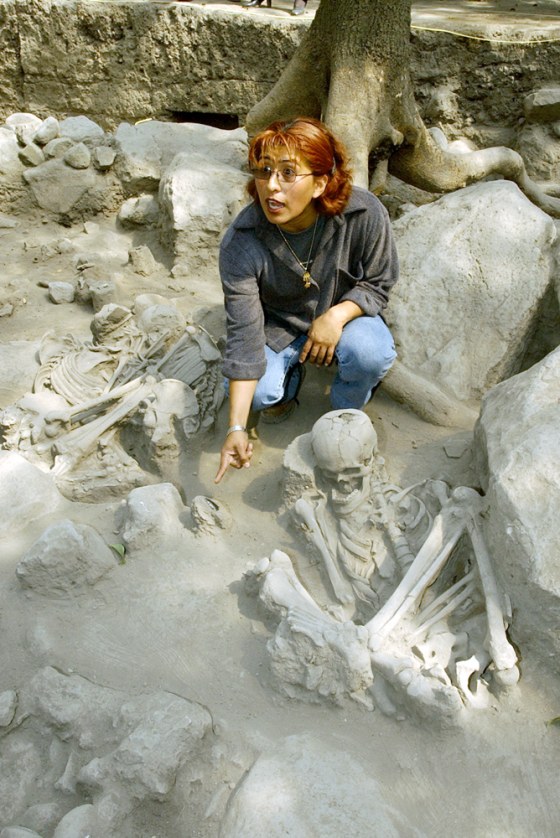 Archaeologist Rocio Morales examines the site where the remains were found on the edge of Mexico City's famous Chapultepec Park.