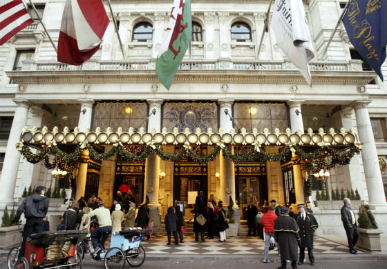 People gather in front of the Plaza Hotel in New York in this December 2004 file photo. The famous hotel with a Central Park view and a history of celebrity will close by April 30 for major renovations.