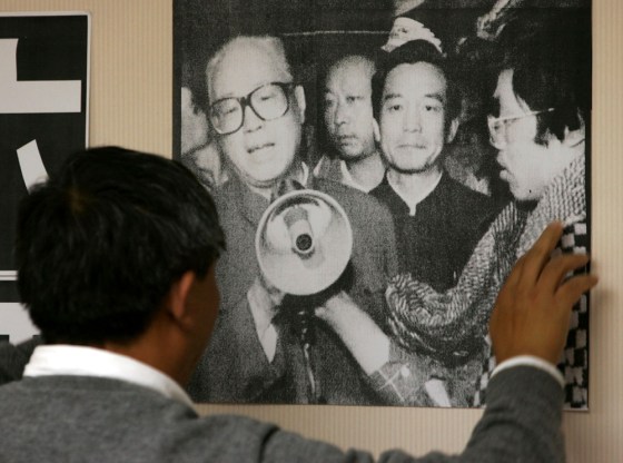 Worker puts up poster of late Zhao Ziyang in Hong Kong
