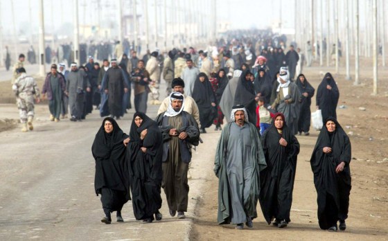 Thousands of Iraqis make a trip on foot to the town of Al Alamara to vote Sunday after all car traffic was prohibited.
