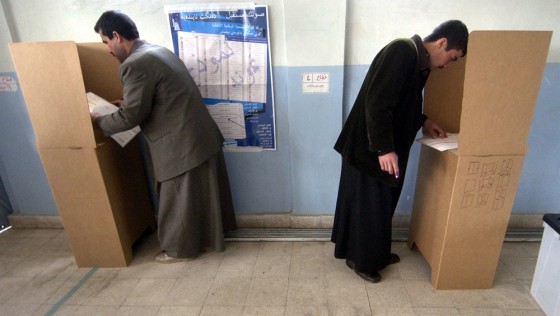 Iraqi men vote at a polling station in Mosul, Iraq, on Sunday.