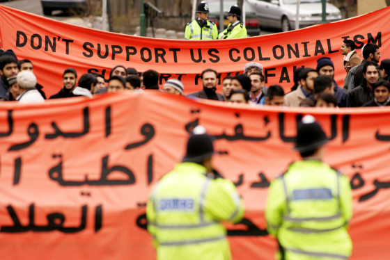 British police watch as demonstrators gather at the London voting center in Wembley, on Sunday.
