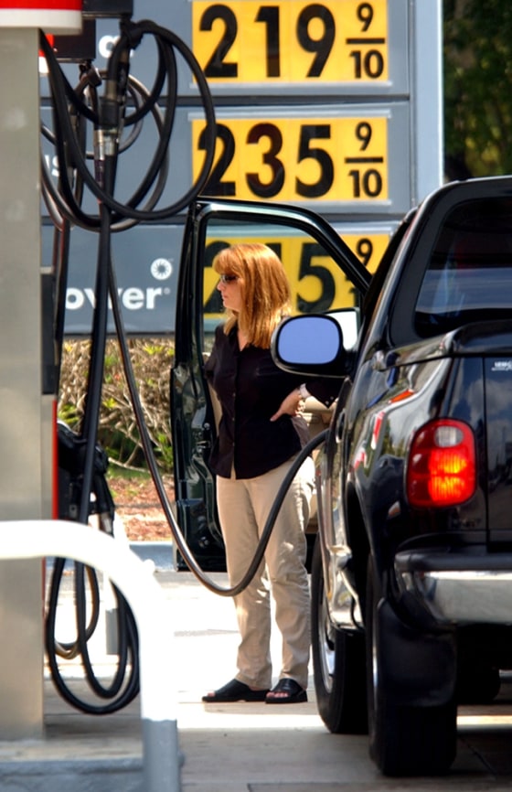An unidentified woman fills her gas tank Monday in Miami. Average U.S. gas prices are at record highs around $2.10 a gallon, AAA reports.