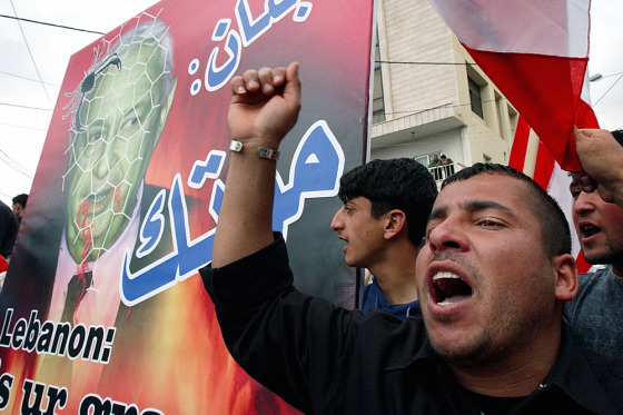 Anti-U.S. Lebanese protesters hold a poster caricaturing Israel's Prime Minister Ariel Sharon in Aukar, northeast of Beirut, on Tuesday.