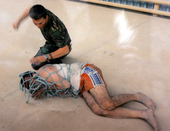 Lance Corporal Mark Cooley, seen here with an Iraqi detainee, is one of two British soldiers who were convicted Wednesday of abusing civilian prisoners.
