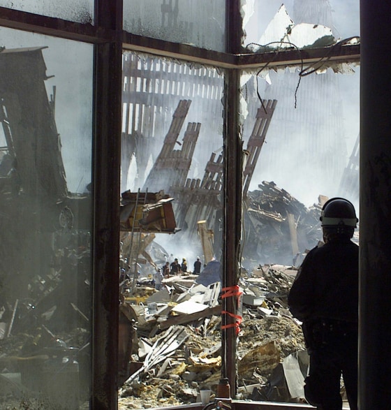NEW YORK CITY POLICE OFFICER LOOKS AT WORLD TRADE CENTER WRECKAGE