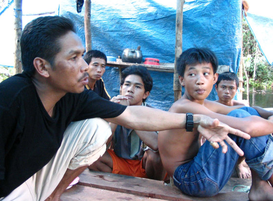 Bastarin, a former wildcat logger, tells illegal loggers in a Borneo rain forest that deforestation is threatening the orangutan.