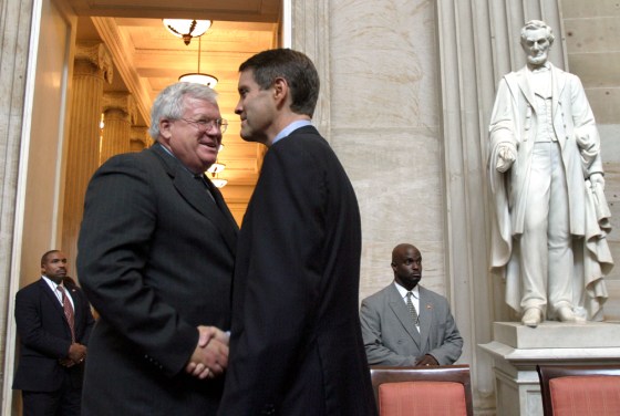 Rep. Dennis Hastert, Speaker of the House of Representatives, left, speaks to Sen. Bill Frist, the Senate Majority Leader, right, at the conclusion of a congressional gold medal ceremony at the U.S. Capitol Rotunda on Sept. 8.