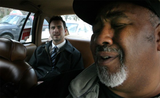 Adrian Brocks, right, a Washington taxi driver, grimaces while discussing traffic with passenger Stacy Lloyd. Brocks' passengers can count on getting an earful about everything from weather, movies, and sports to national politics.