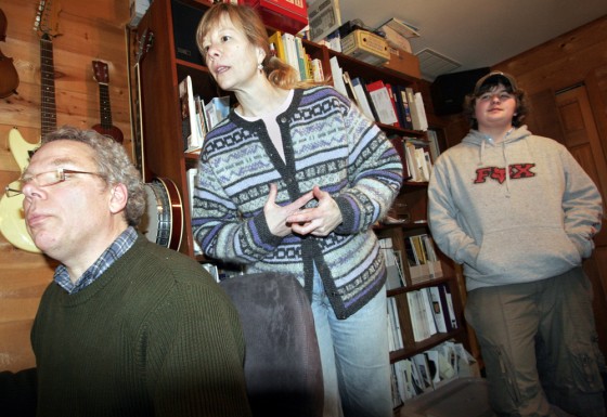 Phil Bowman and Susan Schauer monitor their son's driving habits using a device called a CarChip. Ben Ellison, 15, observes how he did.