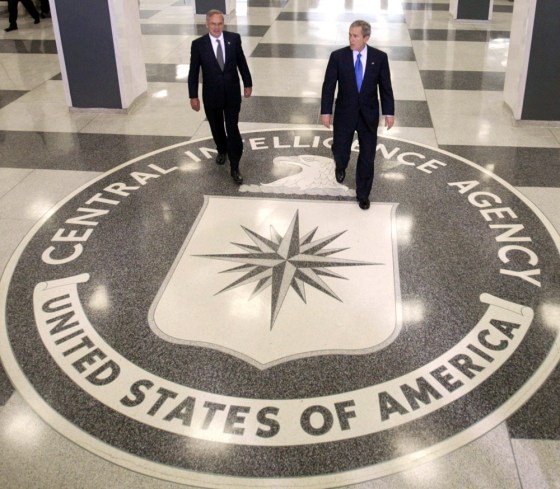 U.S. President George W. Bush and CIA Director Goss walk in the lobby of the CIA headquarters in Langley
