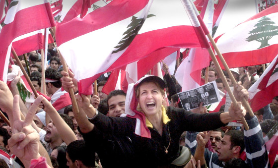 Protestors wave Lebanese flags during a demonstration against Syria in Beirut on Monday.