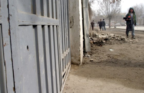 A fresh hole caused by a bullet is seen on the door of a building in Kabul