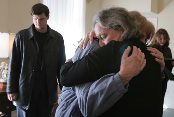 Kidney donor Nancy Nearing, center, gets a hug from Jean Helms, the recipient's wife, before a memorial service for her husband, Arthur Helm, in Alexandria, Va., on March 9. At left is son, William Helms.