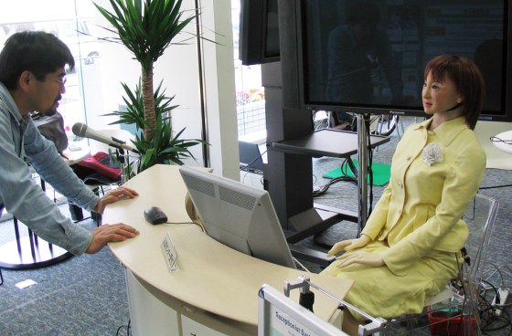Saya the receptionist robot, right, greets Prof. Hiroshi Kobayashi at the Tokyo University of Science.