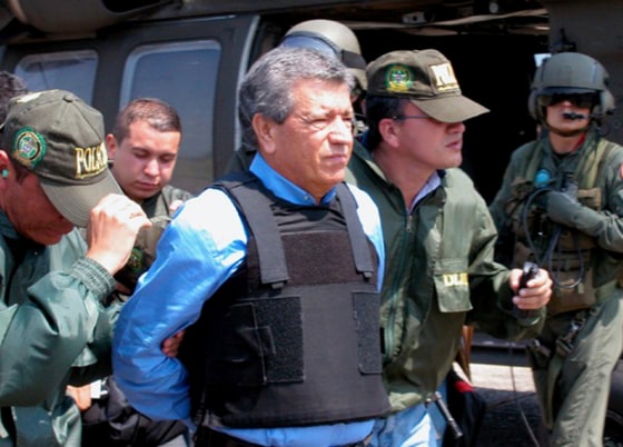 In this photo released by the Colombian National Police, accused drug trafficker Miguel Rodriguez Orejuela, center, is escorted by police officers to a U.S. government airplane at the Palanquero Air Base near Puerto Salgar in central Colombia on Friday to be flown to the United States.