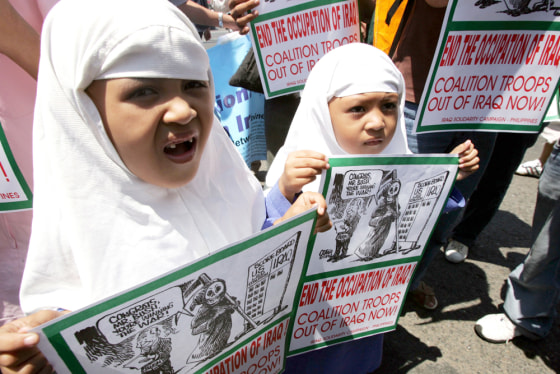 Filipino Muslim girls hold placards during a rally near the US embassy in Manila