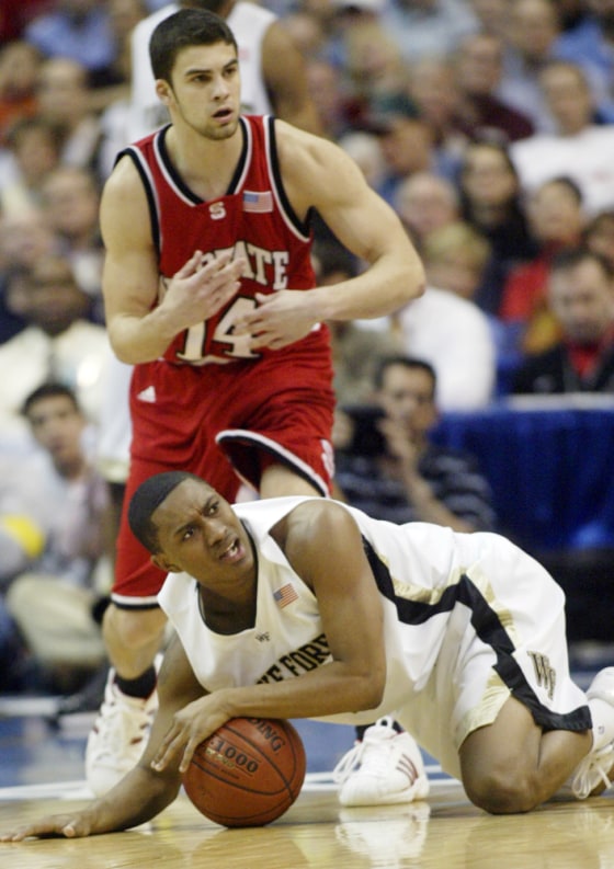 Justin Gray of Wake Forest falls to the floor in front of Engin Atsur of NC State