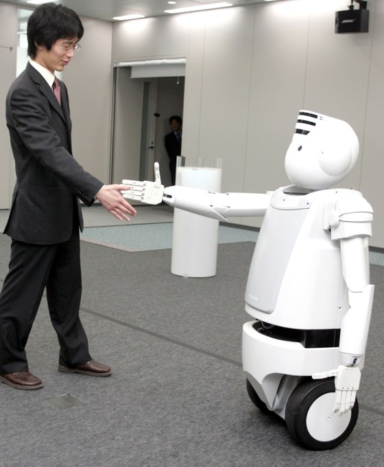 Hitachi's new humanoid robot \"Emiew\" stretches out its arm in Tokyo