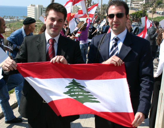 Elias Azzam, right, skipped a meeting Tuesday to join an impromptu celebration along Beirut's waterfront as a portrait of Syrian President Bashar Assad was taken down. 